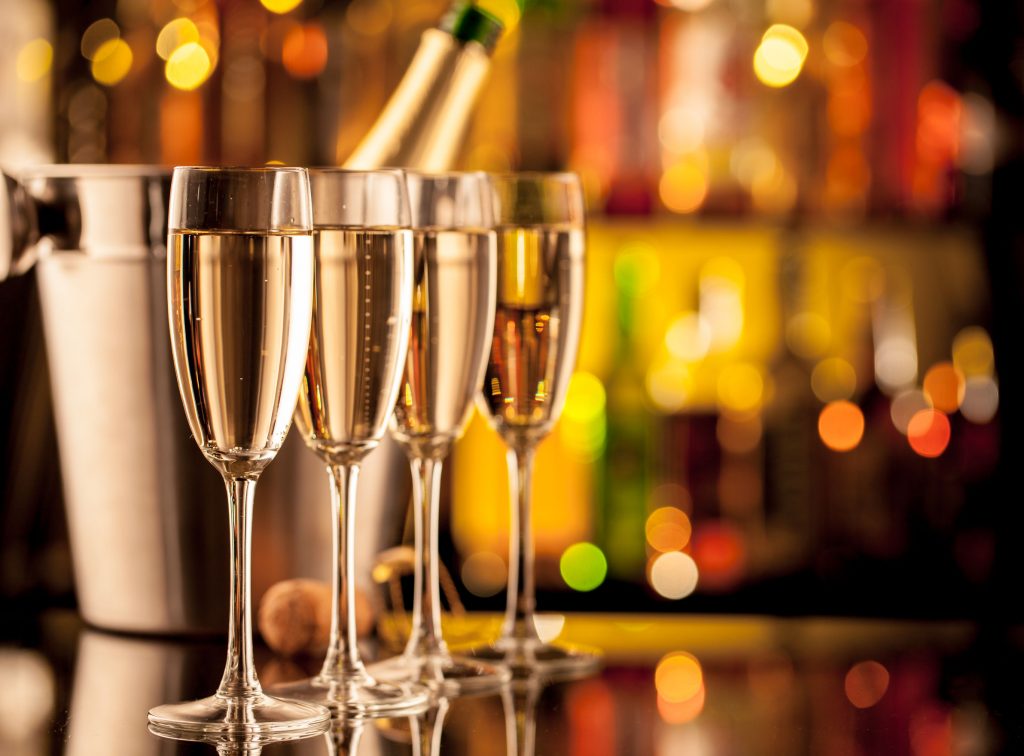 45763264 - glasses of champagne in holiday setting, served on bar counter